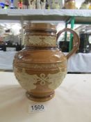 A 19th century Doulton Lambeth salt glaze jug decorated with image of Queen Victoria and shields of