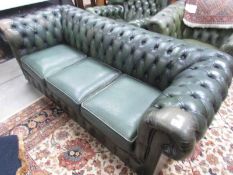 A green leather Chesterfield.