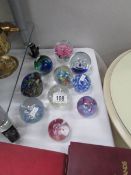 10 assorted glass paperweights.