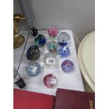 10 assorted glass paperweights.