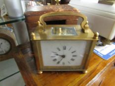 A cased brass carriage clock.
