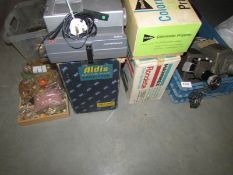 A quantity of vintage film and slide projectors.