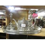 A silver plate tray, pair of candlesticks and tea pot.