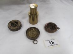 A Dolland of London brass compass, one other brass compass and one other item.