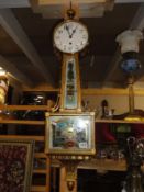 A 1906 'WAterbour' banjo clock, 8 day, single weight, reverse wind, painted verso 'Battle of Hull',