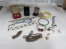 A tray of good costume jewellery including tiger's eye bracelet and deco style clip.