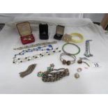 A tray of good costume jewellery including tiger's eye bracelet and deco style clip.