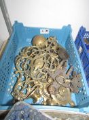 A tray of assorted brass lamp parts etc.