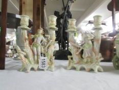 A pair of continental porcelain figural candlesticks.