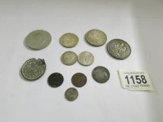 A mixed lot of old coins including some silver.