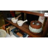 A shelf of pestle and mortars etc.