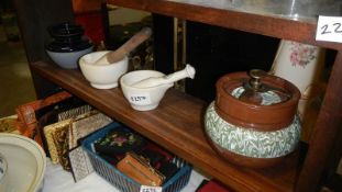 A shelf of pestle and mortars etc.