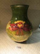 A large limited edition (66/200) green Moorcroft vase, dated 1983.