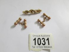 A 9ct gold bar brooch and a pair of 9ct gold 'bar bell' cuff links, 8.9 grams.