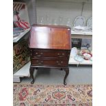 A small mahogany bureau.