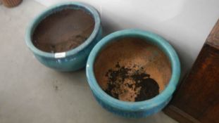 A pair of modern turquoise plant pots.