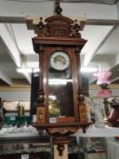 An art nouveau musical 8 day wall clock in walnut case, strikes on the hour.