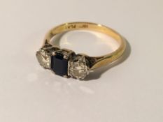 An 18ct gold ring set central sapphire and 2 shoulder diamonds, size N.