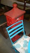 A red cast metal post box.