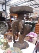 A wooden carved elephant stand.