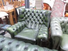 A green leather wing arm chair.