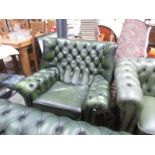 A green leather wing arm chair.