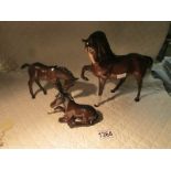 A large Beswick horse and 2 smaller examples.