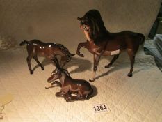 A large Beswick horse and 2 smaller examples.