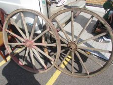 A pair of old cart wheels.