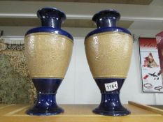 A pair of Royal Doulton salt glaze vases.
