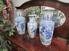 A pair of blue and white vases and one other.