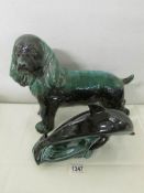 A large Blue Mountain pottery spaniel and a Poole pottery dolphin.