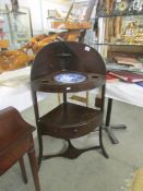 A Georgian mahogany corner washstand with later bowl.