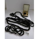 A quantity of French and Whitby jet vintage jewellery consisting of necklaces, brooch etc.