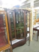 An Edwardian inlaid bow fronted display cabinet.