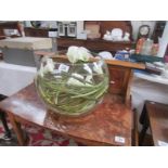 A large glass bowl decorated with arum lilies,.