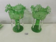 A pair of green glass lustres.