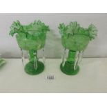 A pair of green glass lustres.