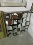 An unusual multi faceted designer mirror.