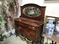 A mahogany mirror backed sideboard.