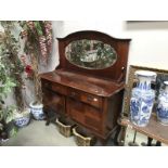 A mahogany mirror backed sideboard.