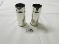 A pair of silver plated trench art vases.