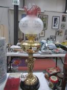 A brass cherub oil lamp with shade.