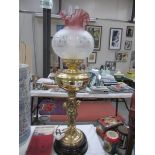 A brass cherub oil lamp with shade.