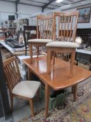 A modern dining table and 4 chairs.