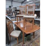 A modern dining table and 4 chairs.