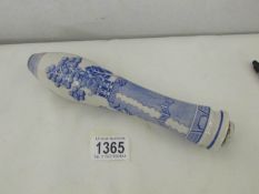 A blue and white willow pattern bar pump handle.