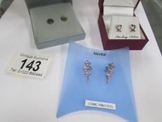 3 pairs of silver earrings.