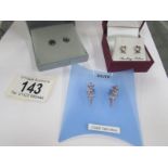 3 pairs of silver earrings.