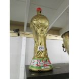 A 1990 Italian whisky decanter in the shape of the world cup trophy.